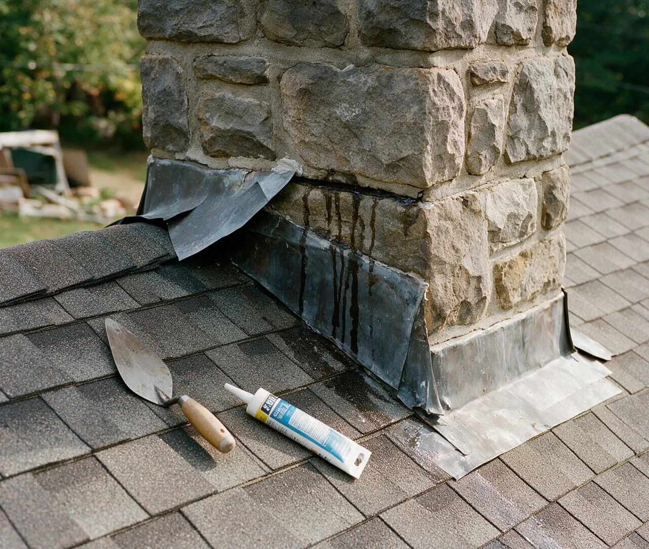 Counterflashing on a stone chimney